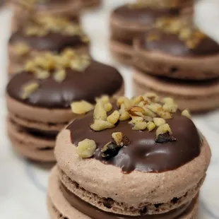 chocolate macarons with walnuts on top