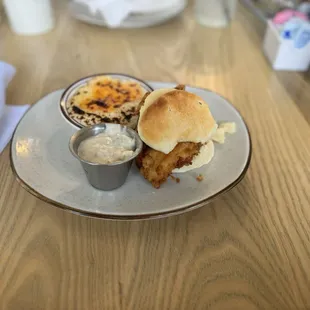 Fried chicken biscuit, with a side of cheese grits