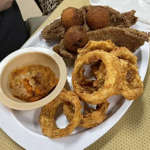 Catfish, onion rings, sweet potato casserole, and hush puppies.