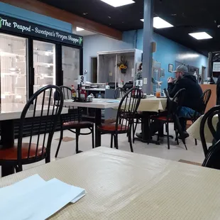 a man sitting at a table in a restaurant