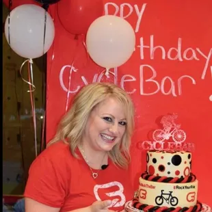 a woman holding a birthday cake