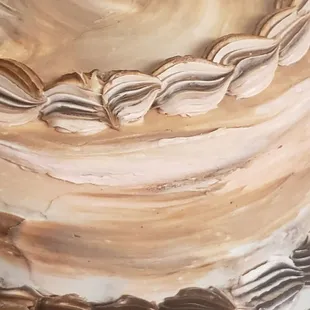 Neopolitan 3 layer cake(Vanilla, Strawberry, and Chocolate Cake)with swirled icing to accommodate.