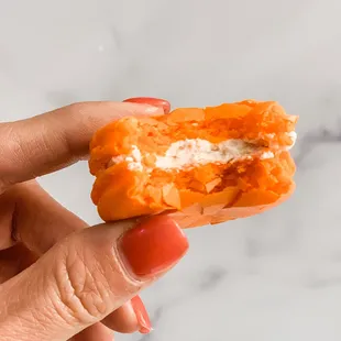 a hand holding a half eaten doughnut