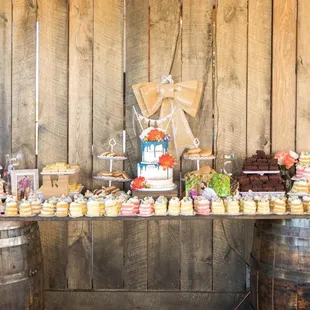 a table of cupcakes and cakes