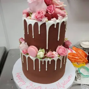 a chocolate cake decorated with pink roses