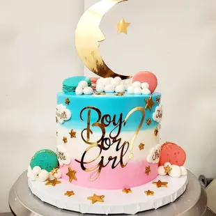 Gender reveal cake with mirror topper and font, gold stars and custom french macarons.