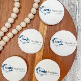 a bead necklace and four round badges