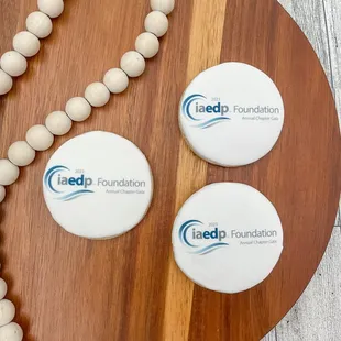 a bead necklace and two round badges