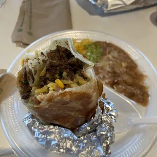 Yummy carne Asada burrito (rice (added), beans, cheese, cilantro and onion)