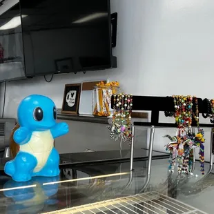 a glass counter with a tv in the background