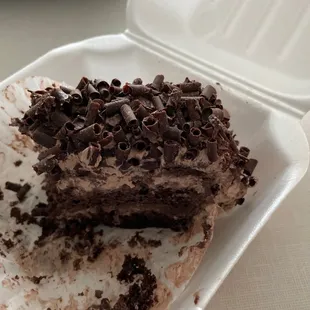 a chocolate cake in a styrofoam container
