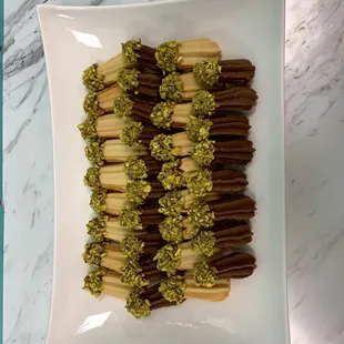 a plate of chocolate and pistachios