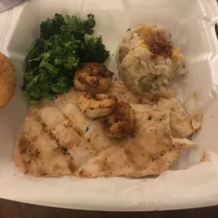 Chicken and shrimp with broccoli and mashed potatoes.