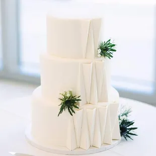 a three tiered white wedding cake