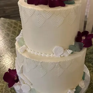 Elegant ivory beach theme with impressive stencil work, beautiful seashells and real flowers.