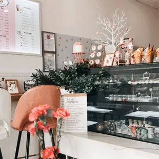 pink flowers in a vase in front of the counter