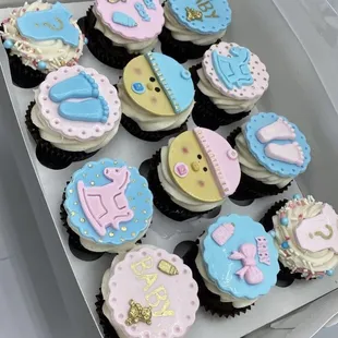 a box of decorated cupcakes