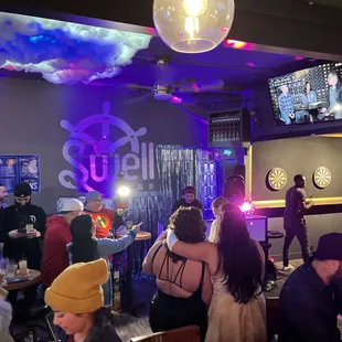 a group of people sitting at a bar