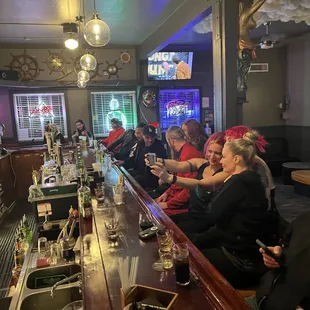 a group of people sitting at a bar