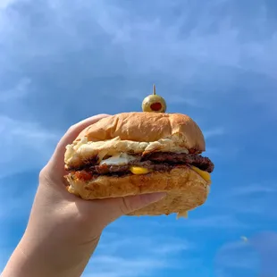 a hand holding a sandwich