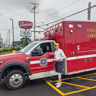 a man standing next to a fire truck