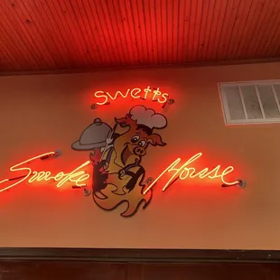 a neon sign for swett&apos;s smoke house