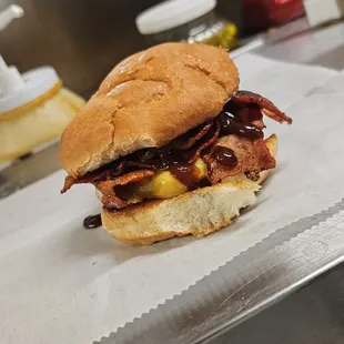 a bacon and cheese sandwich on a bun