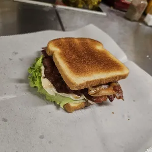a toasted sandwich with bacon and lettuce