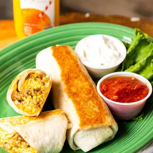 a plate of burritos with salsa