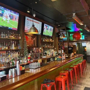 a bar with red stools