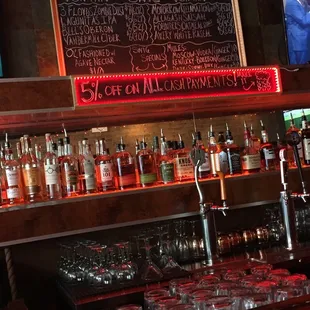 a bar filled with liquor bottles and glasses