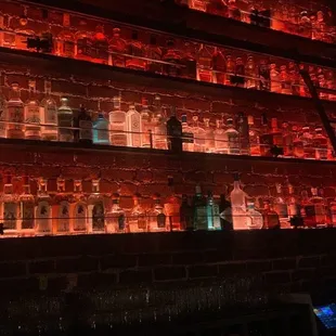 bottles of liquor on a brick wall
