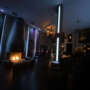 a living room with a fireplace and a chandelier