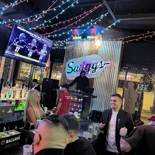 a group of people sitting at a bar