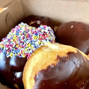 Chocolate frosted, sprinkles, and 2 Boston crème.