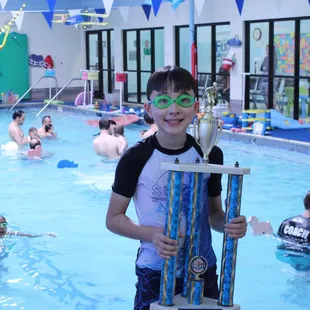 When a swimmer finishes our program, they are awarded the coveted Level 10 Graduate trophy!