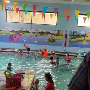 Teaching children how to support themselves with by the side of the pool and climb out