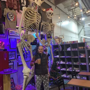 a man standing in front of a skeleton