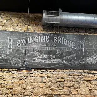 a sign on a brick wall