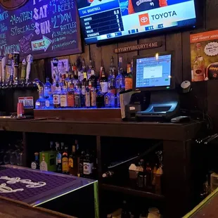 a bar with a large screen tv