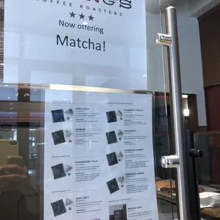 a sign in the window of a coffee shop