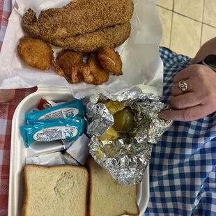 Catfish meal with shrimp and fried okra and baked potato.