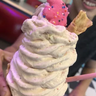 Circus cookie with waffle cone mixed into the ice cream on a regular waffle cone