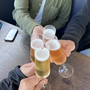 a group of people clinking glasses of beer