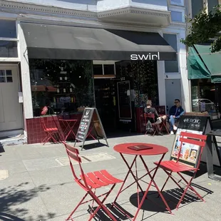 View of Swirl / Heroic Italian's front tables in the sun.