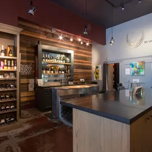 Wine bar area -- seating available at the main bar, island and 2 side tables. Ample standing space to hangout &amp; enjoy some excellent vino!