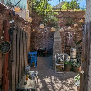 Outside patio area wraps around building, lots of cozy tables