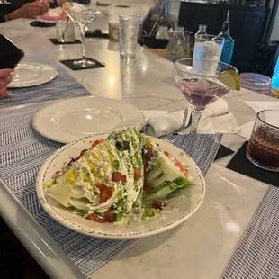 a plate of salad and a glass of wine