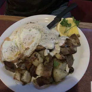 a plate of food with eggs and potatoes