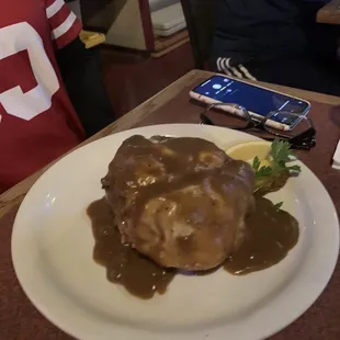 a white plate with gravy on it